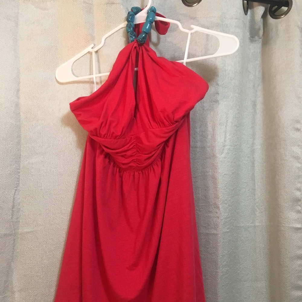 Red halter top with blue beads around the neck.